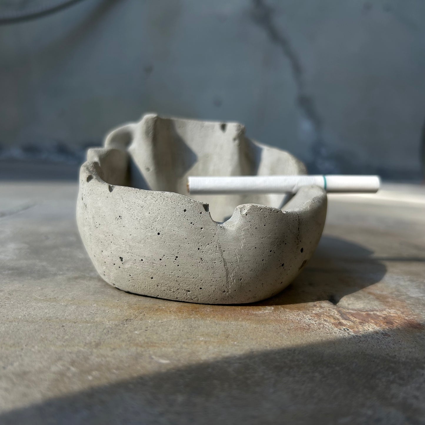 Raw concrete skull ashtray